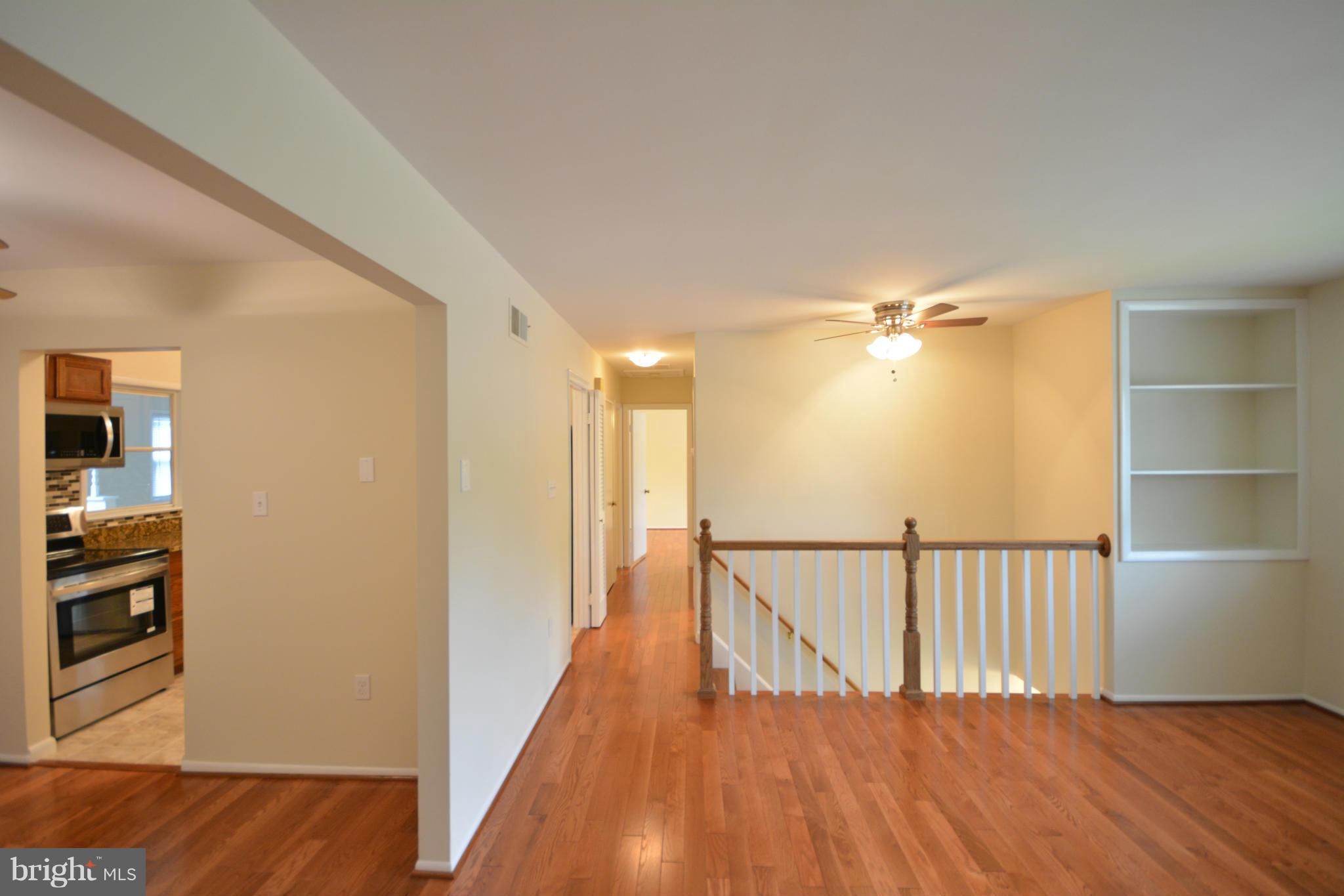 13203 Delaney Road Woodbridge, VA 22193 - Photo 17 of 30 a view of a hallway with wooden floor and staircase