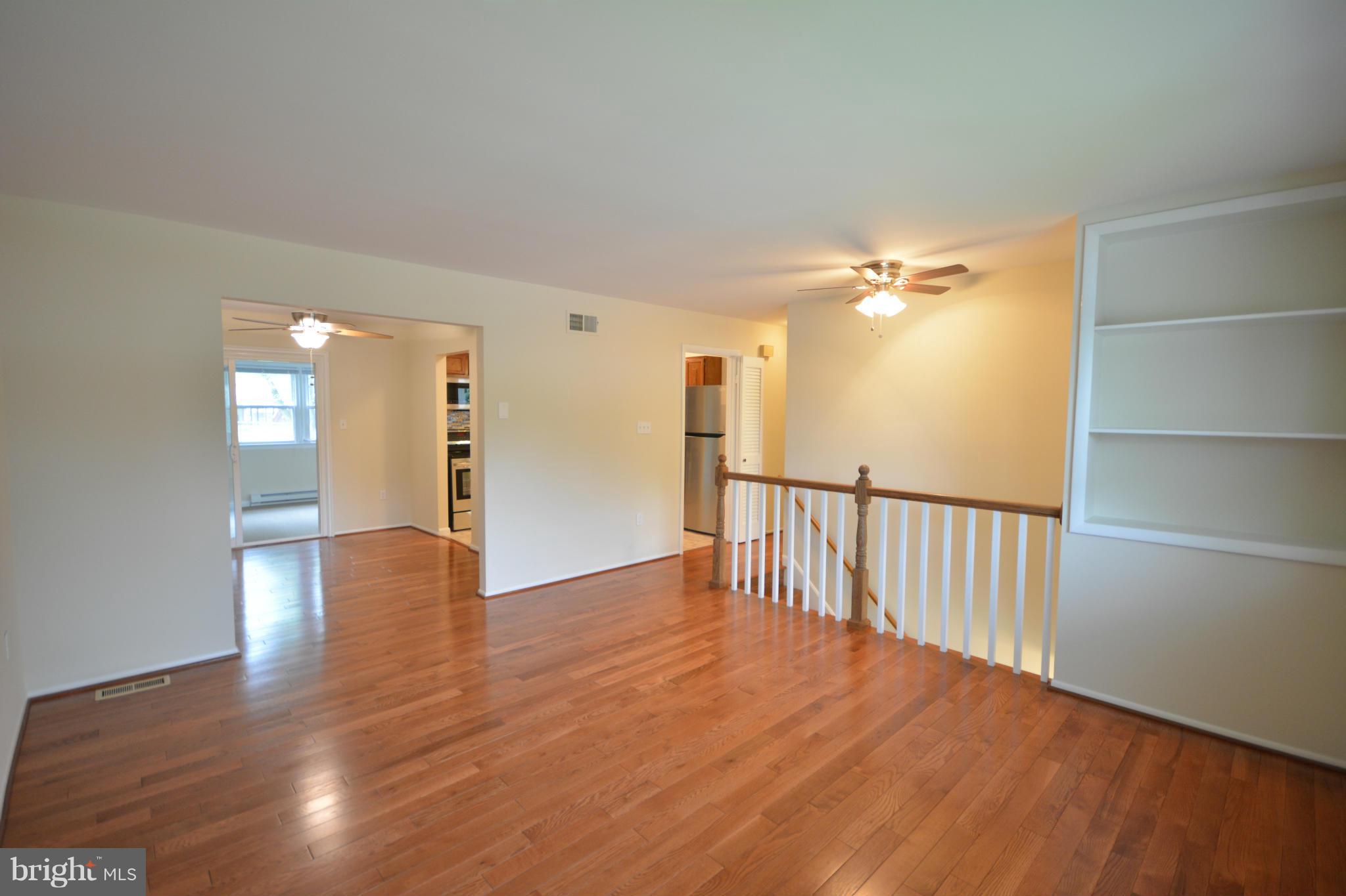 13203 Delaney Road Woodbridge, VA 22193 - Photo 18 of 30 a view of an empty room with wooden floor and a window