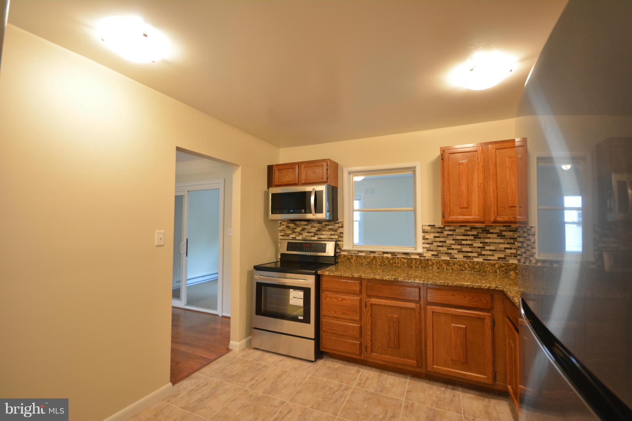 13203 Delaney Road Woodbridge, VA 22193 - Photo 19 of 30 a spacious bathroom with a granite countertop sink and a mirror