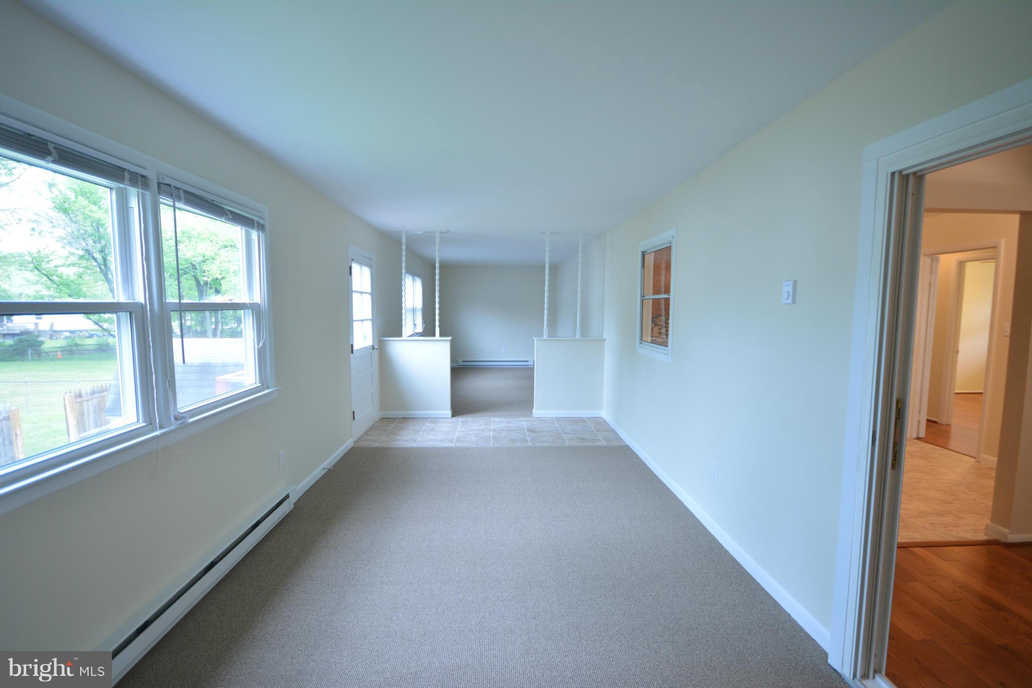 13203 Delaney Road Woodbridge, VA 22193 - Photo 22 of 30 a view of a big room with windows and chandelier