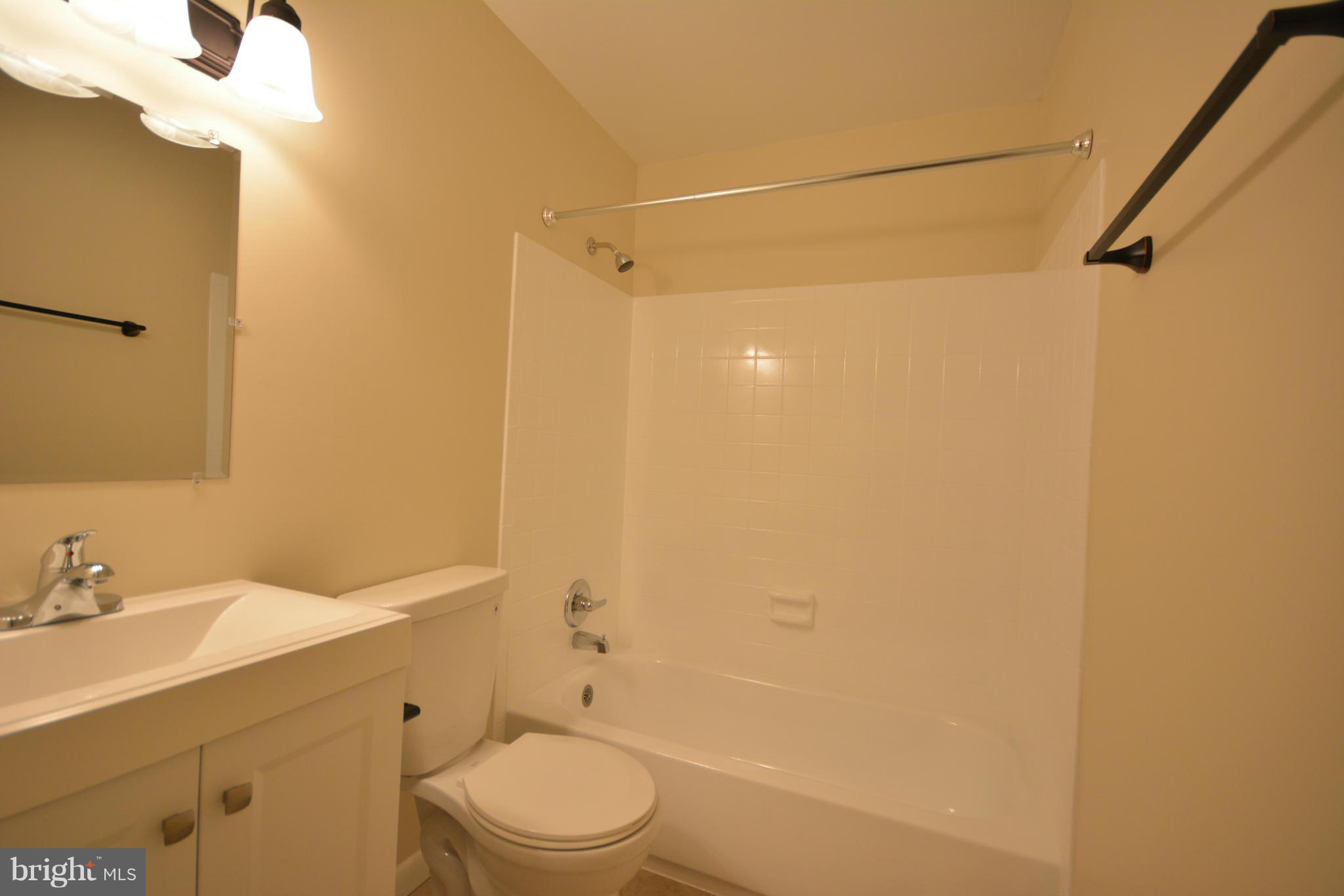 13203 Delaney Road Woodbridge, VA 22193 - Photo 25 of 30 a bathroom with a sink mirror vanity and toilet