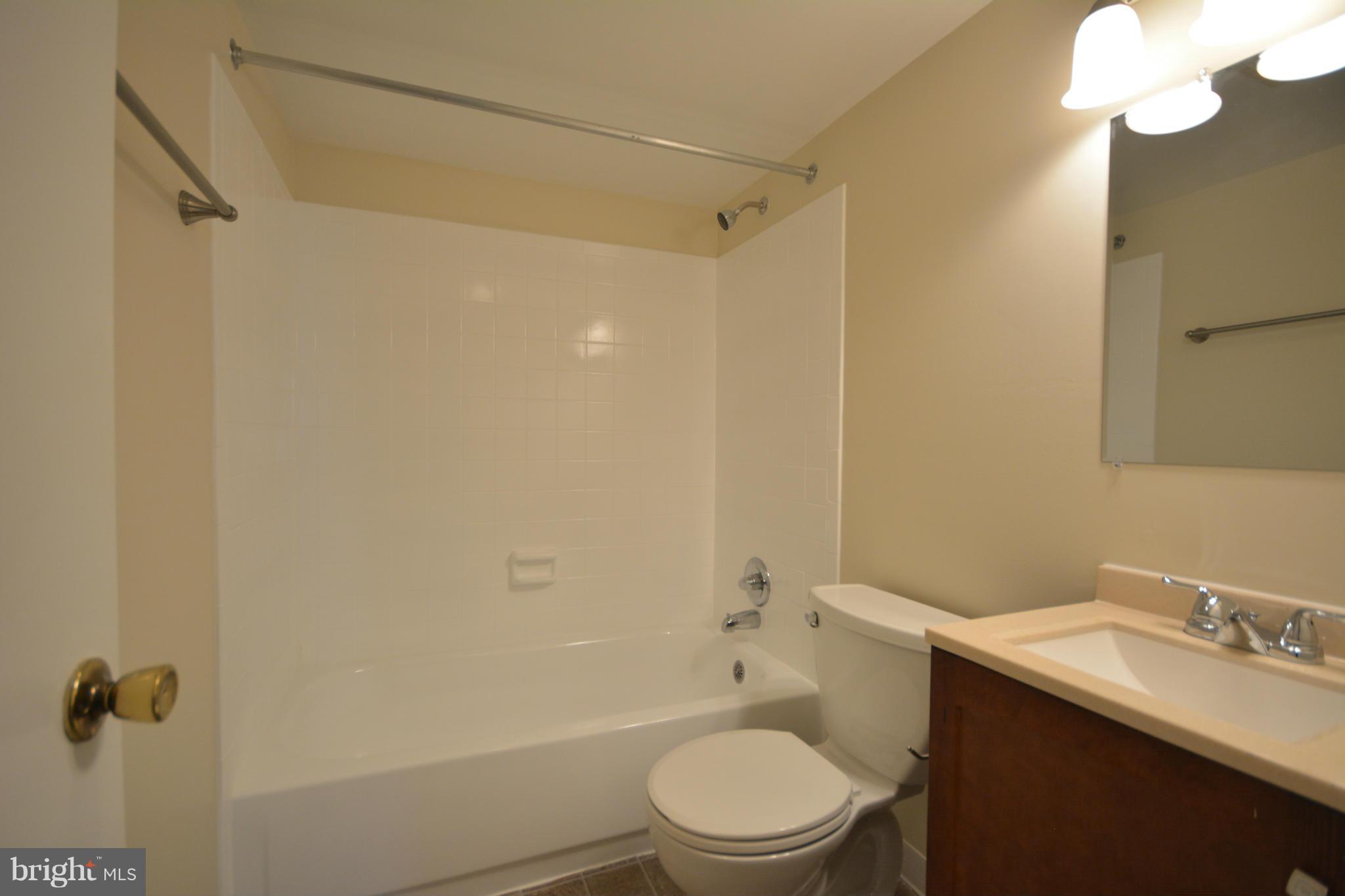 13203 Delaney Road Woodbridge, VA 22193 - Photo 5 of 30 a bathroom with a sink a toilet and shower