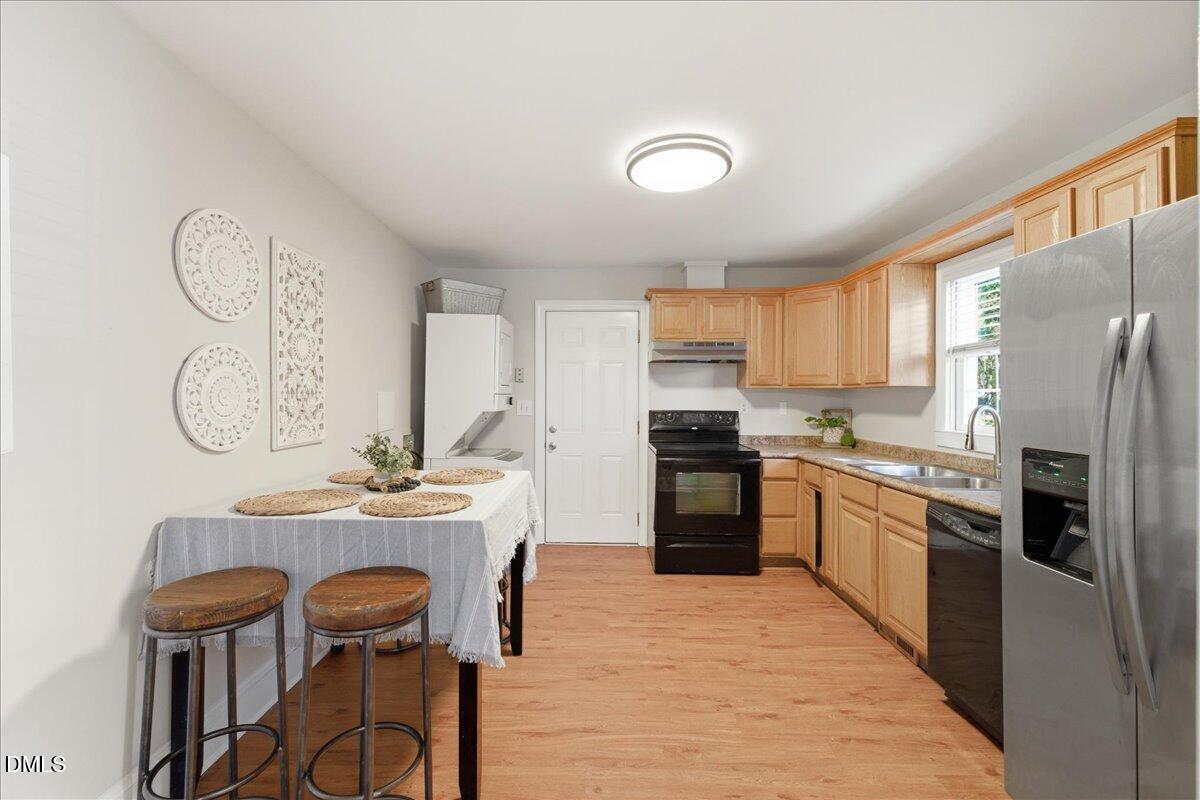 809 Dupree Street Durham, NC 27701 - Photo 11 of 24 a kitchen with a refrigerator a stove top oven a sink dishwasher and white appliances