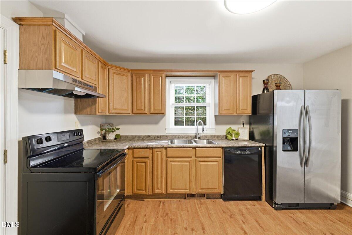 809 Dupree Street Durham, NC 27701 - Photo 13 of 24 a kitchen with a sink stove and refrigerator