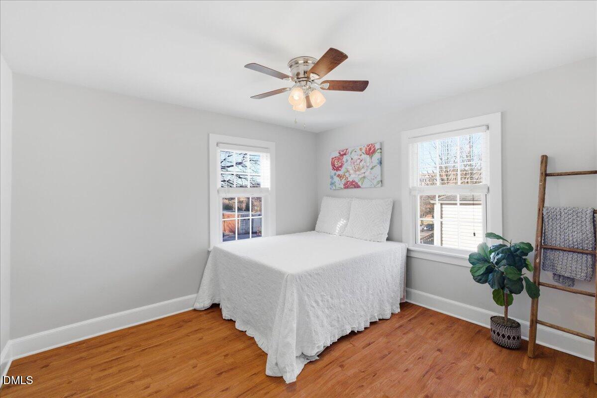 809 Dupree Street Durham, NC 27701 - Photo 17 of 24 a bedroom with a bed and a window