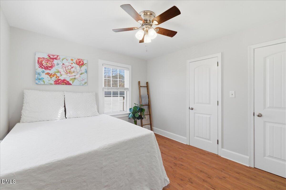 809 Dupree Street Durham, NC 27701 - Photo 18 of 24 a bedroom with a bed and a chandelier