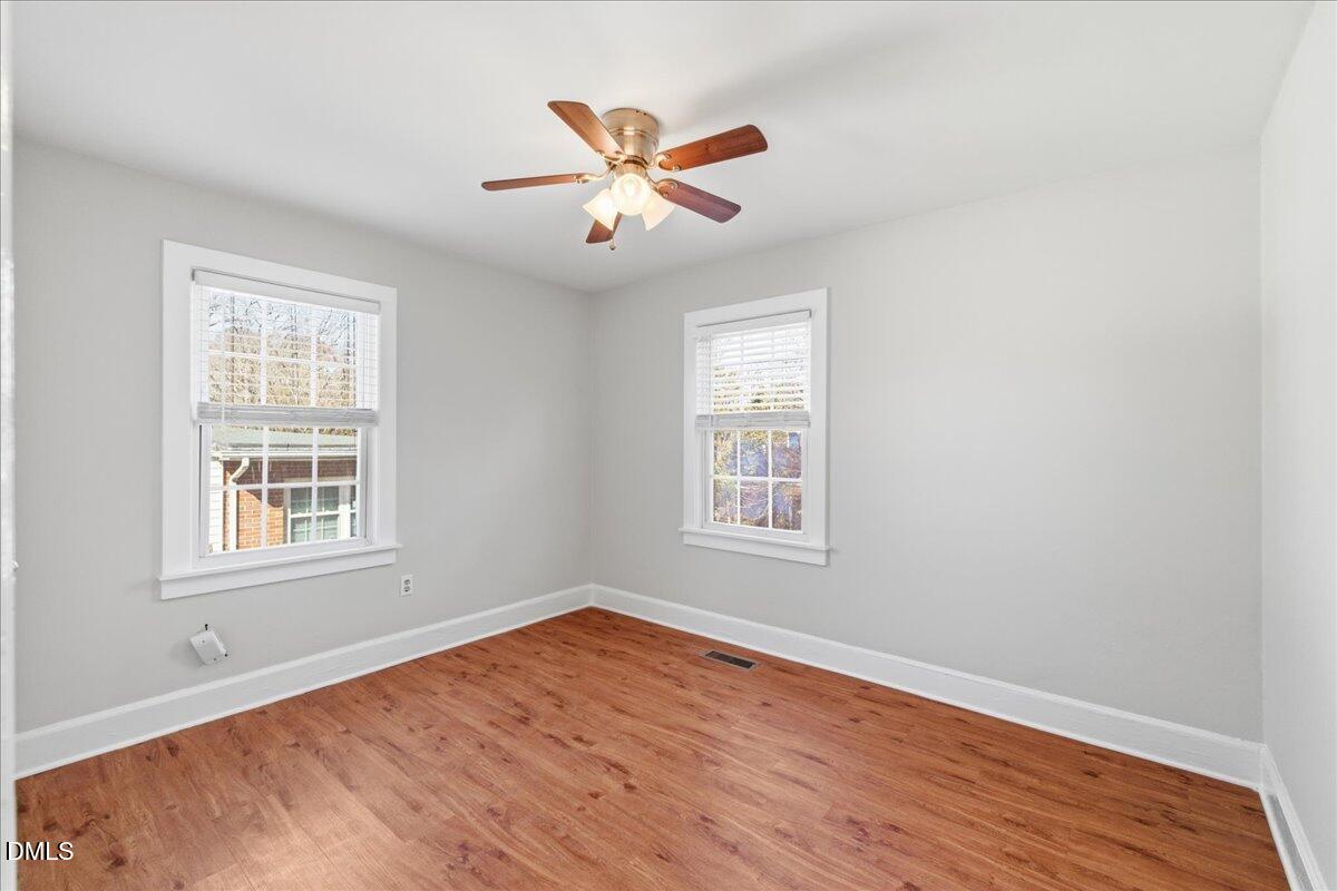 809 Dupree Street Durham, NC 27701 - Photo 19 of 24 an empty room with wooden floor fan and windows