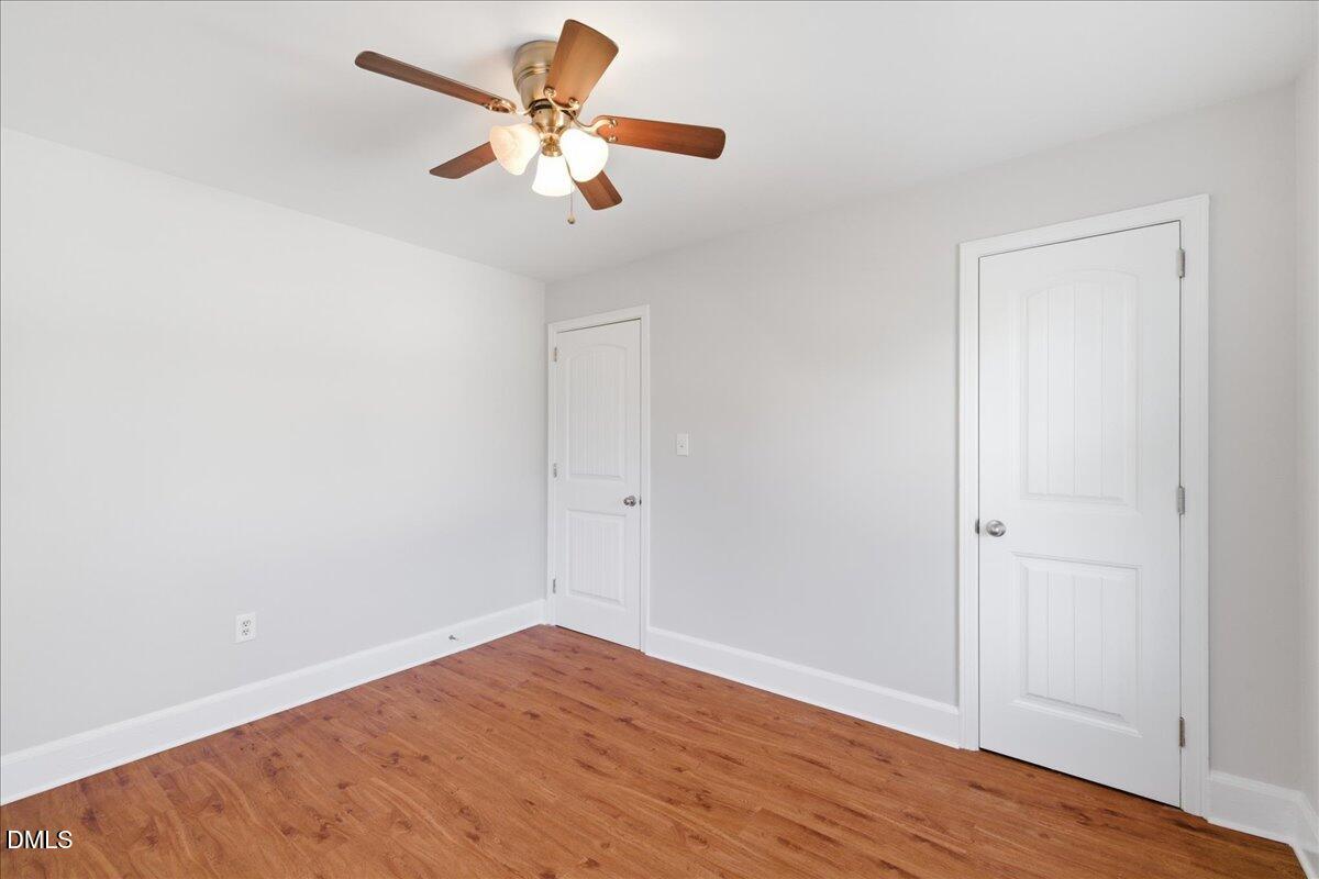 809 Dupree Street Durham, NC 27701 - Photo 20 of 24 an empty room with wooden floor and ceiling fan
