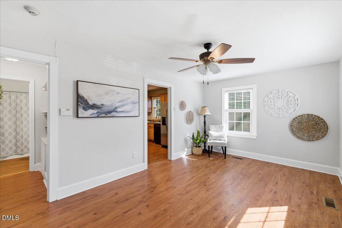 809 Dupree Street Durham, NC 27701 - Photo 8 of 24 a view of a livingroom with furniture a ceiling fan and wooden floor