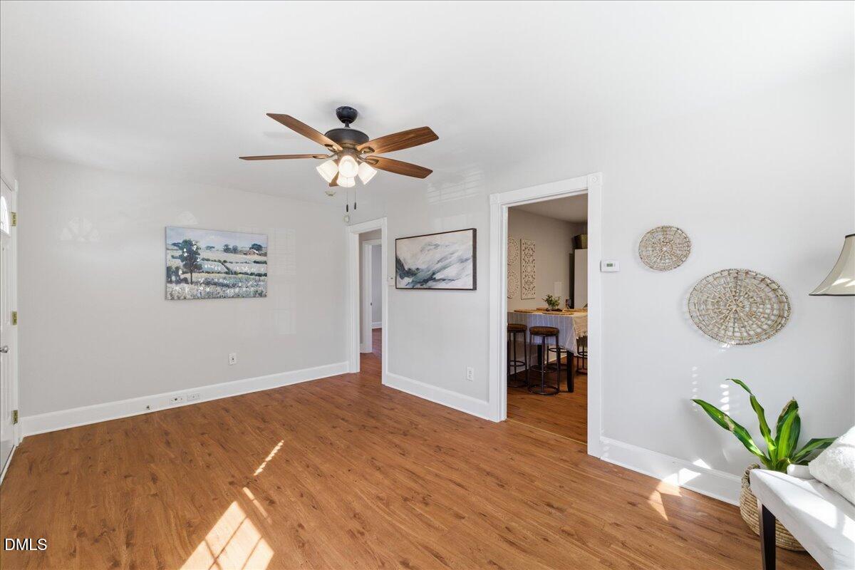 809 Dupree Street Durham, NC 27701 - Photo 10 of 24 a view of a room with wooden floor and a ceiling fan