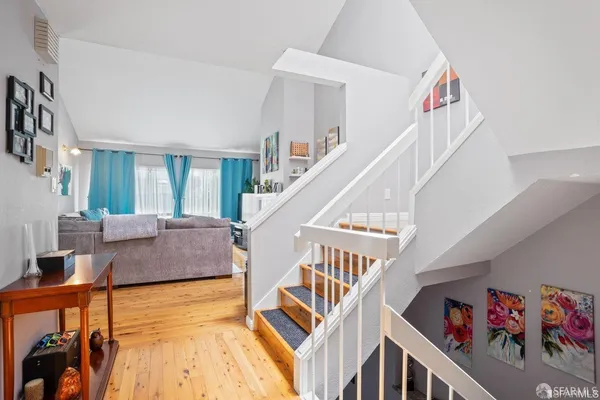 a living room with furniture and stairs