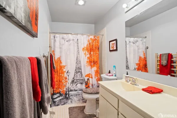 a bathroom with a sink vanity and a large mirror