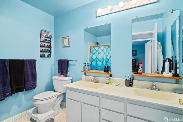 a bathroom with a toilet sink and mirror