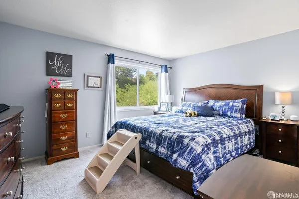 a bedroom with a bed and a chair