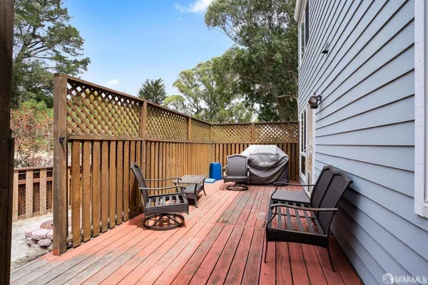 a view of balcony with wooden floor and outdoor seating