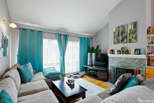 a living room with fireplace furniture and a flat screen tv