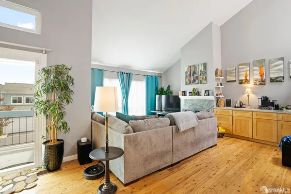 a living room with furniture and a kitchen view
