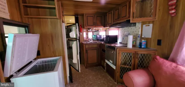 a view of a hallway with wooden floor and door