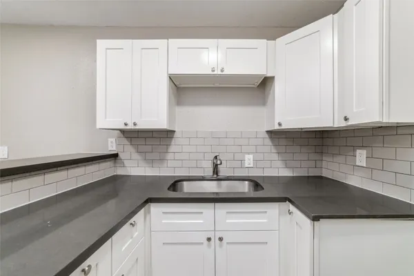 a kitchen with a sink and cabinets