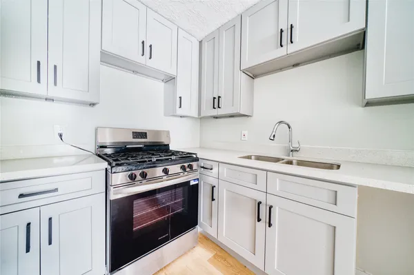 a kitchen with cabinets appliances and a sink