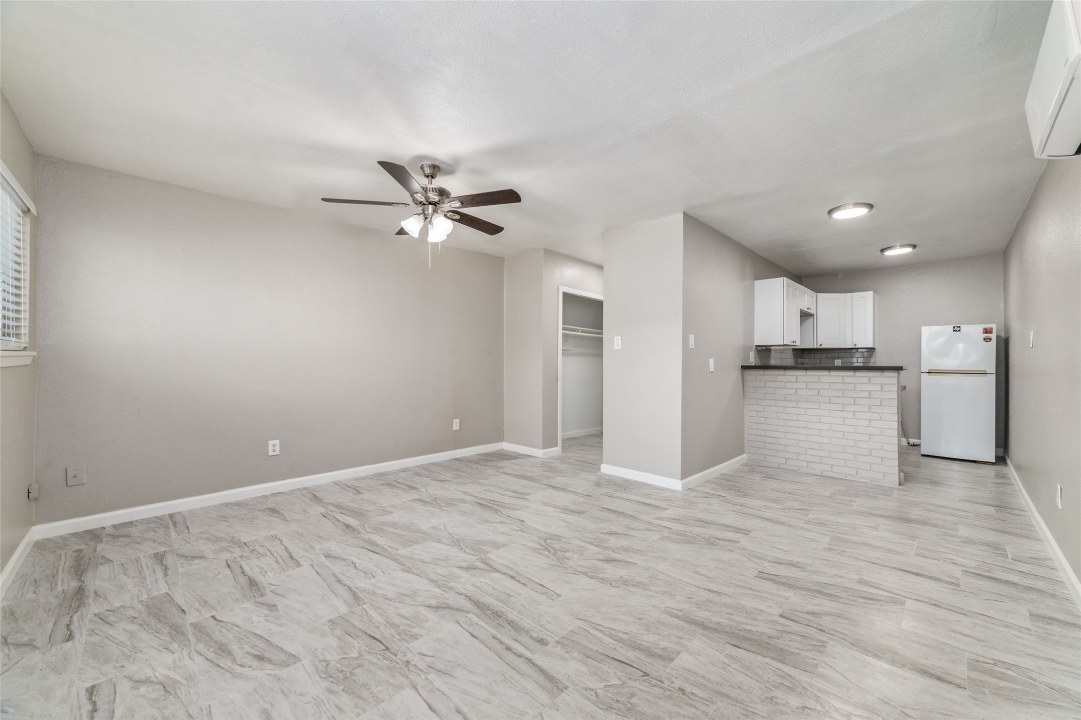 1424 Marshall Street, Unit 9 Houston, TX 77006 - Photo 10 of 17 a view of a kitchen with a sink and a refrigerator