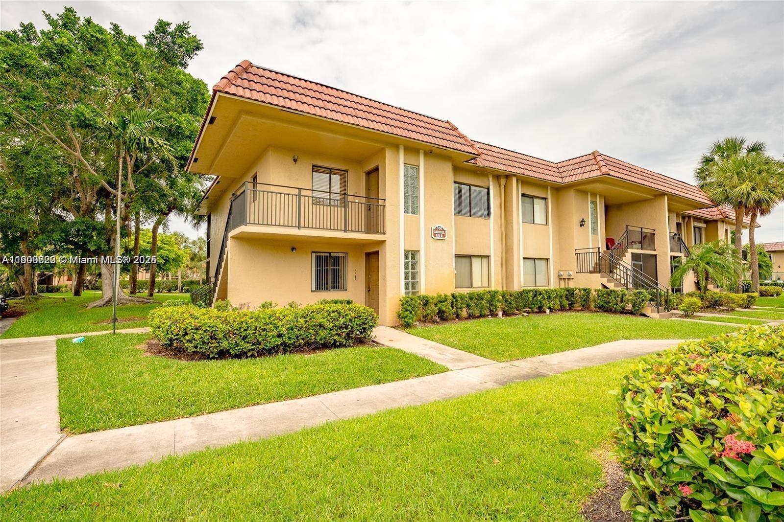 350 Lakeview Drive, Unit 201 Weston, FL 33326 - Photo 1 of 14 a front view of house with yard and green space