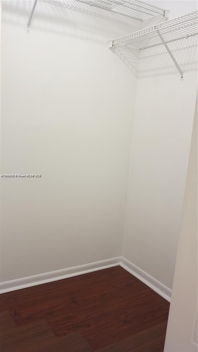 350 Lakeview Drive, Unit 201 Weston, FL 33326 - Photo 6 of 14 a view of a small space with wooden floor and a window