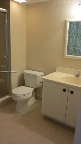 a white toilet sitting next to a bathroom sink