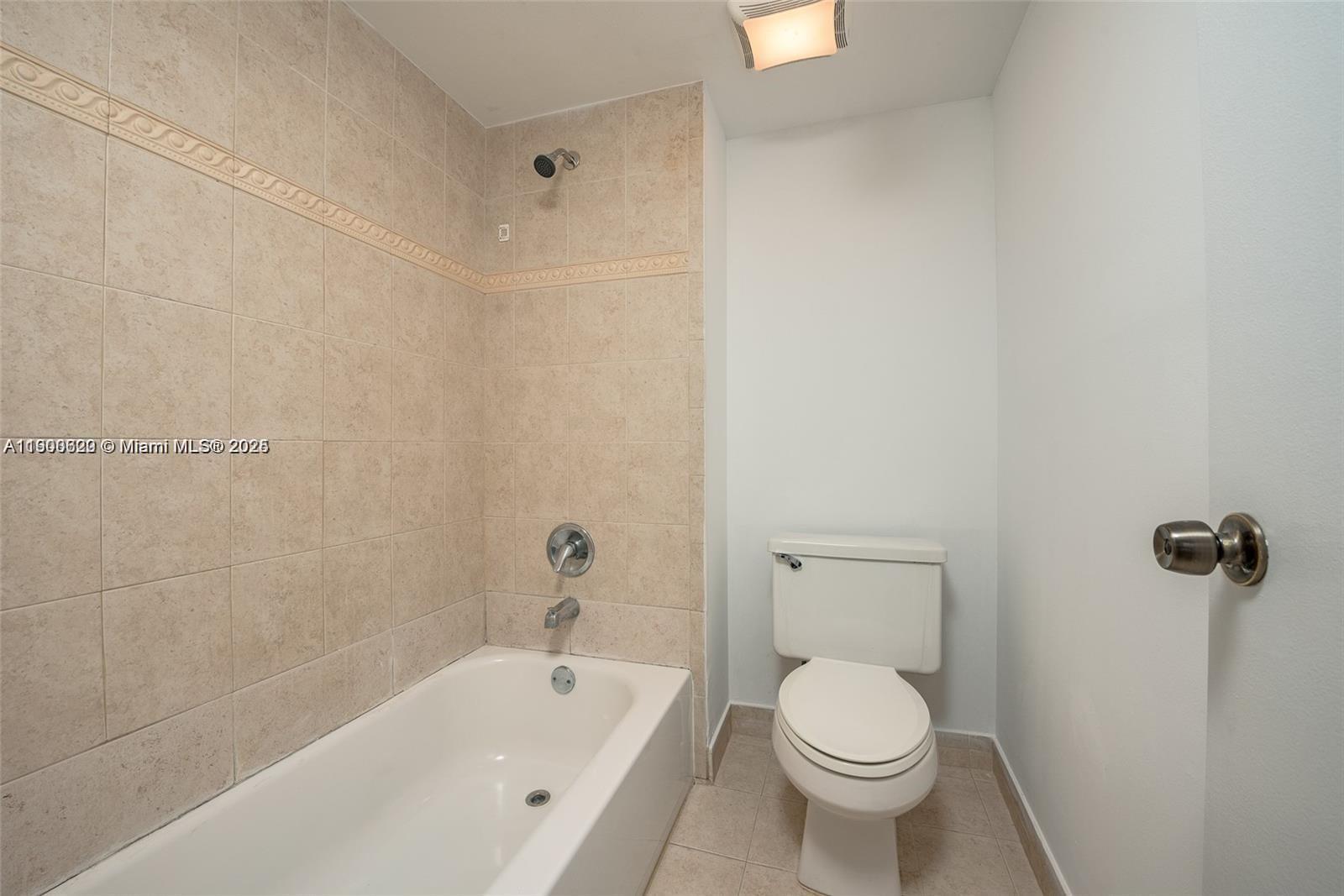 350 Lakeview Drive, Unit 201 Weston, FL 33326 - Photo 9 of 14 a white toilet sitting next to a bath tub and a shower
