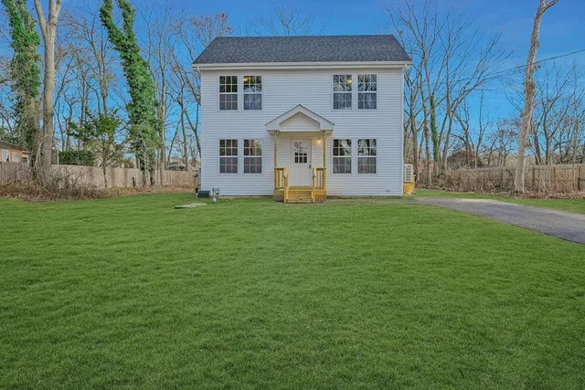 a large house with a garden and trees