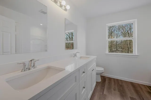 a bathroom with 2 sink tub and a mirror