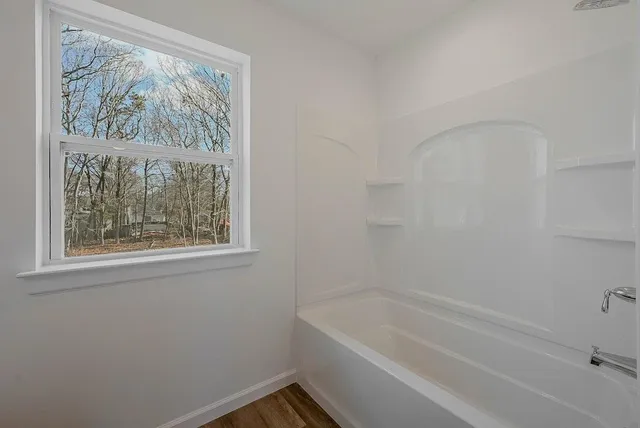 a bathroom with a bathtub and window
