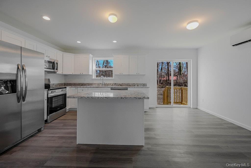 New Construction Neighborhood Road Mastic Beach, NY 11951 - Photo 7 of 28 a kitchen with stainless steel appliances granite countertop a stove a sink and a refrigerator