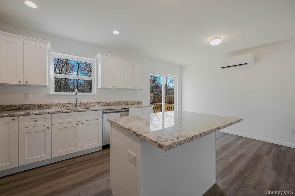 New Construction Neighborhood Road Mastic Beach, NY 11951 - Photo 8 of 28 a kitchen with granite countertop a sink and white cabinets