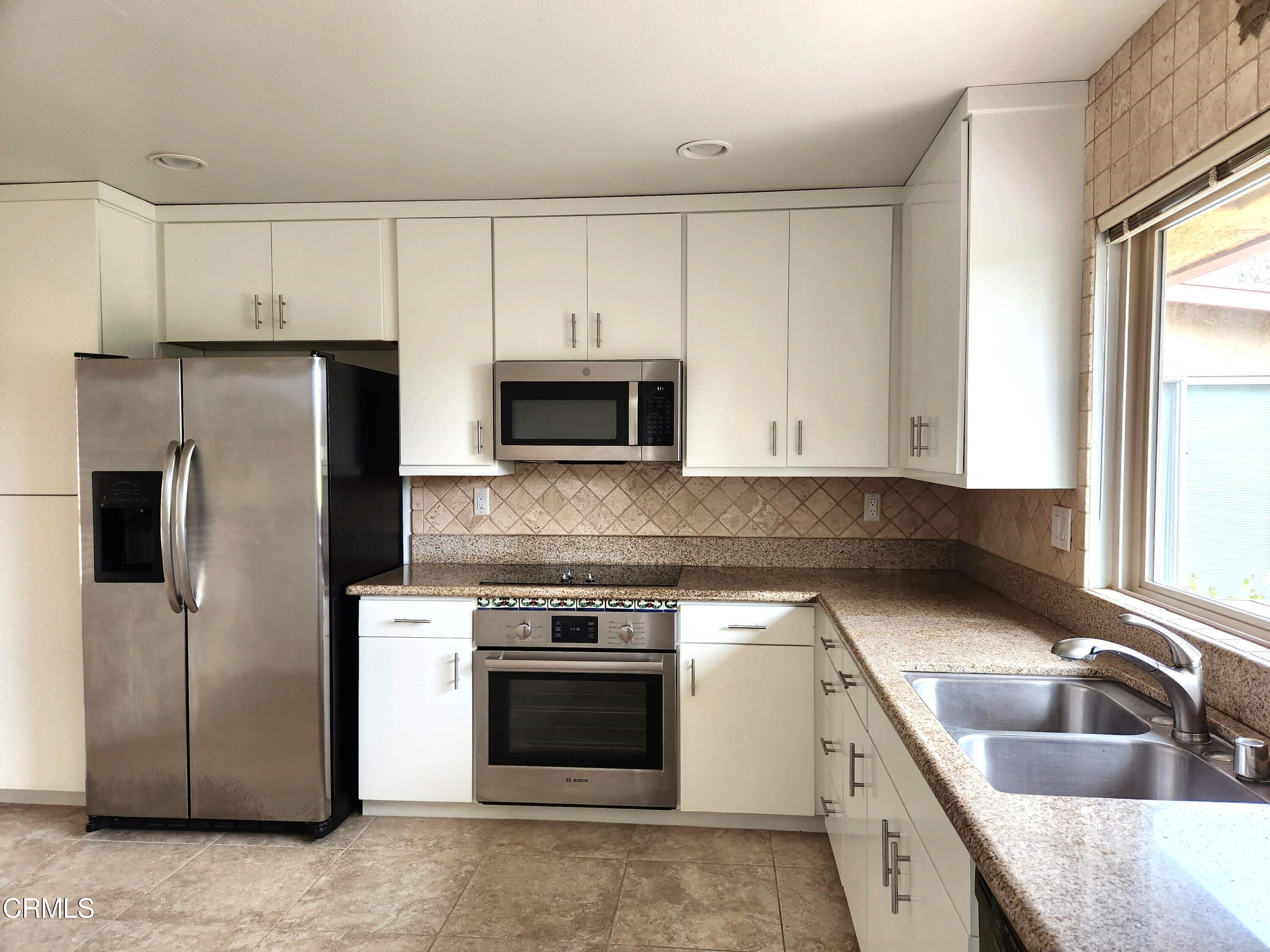 4113 Village 4 Camarillo, CA 93012 - Photo 8 of 50 a kitchen with a sink stove and refrigerator