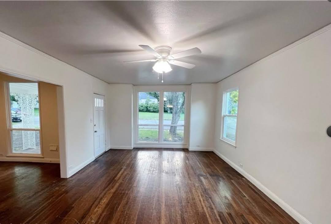 809 North 8th Street Temple, TX 76501 - Photo 7 of 20 Rich hardwood floors welcome you into this light-filled living space, ready for your personal touch.