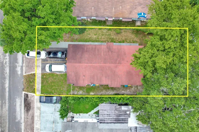 an aerial view of a house with a garden and a yard