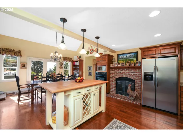 a open kitchen with stainless steel appliances granite countertop a stove and refrigerator