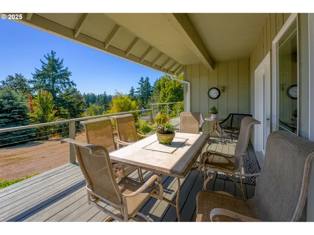 a view of a dining table and chairs in the balcony
