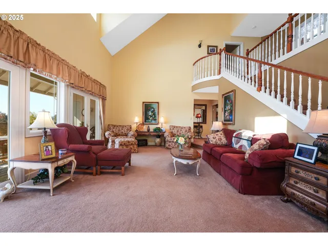 a living room with furniture a fireplace and a large window