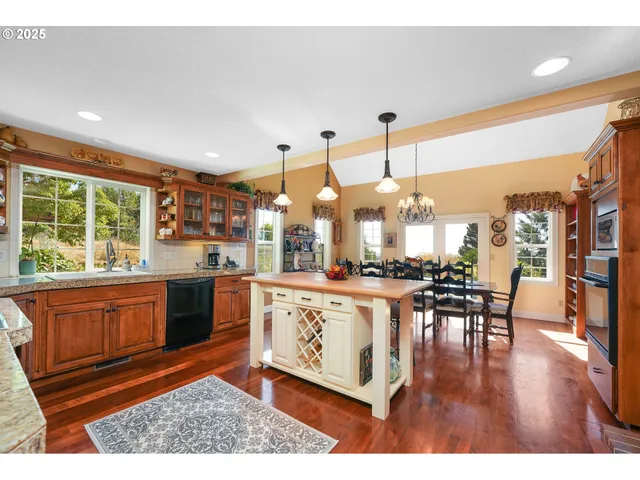 a living room with furniture a large window and wooden floor