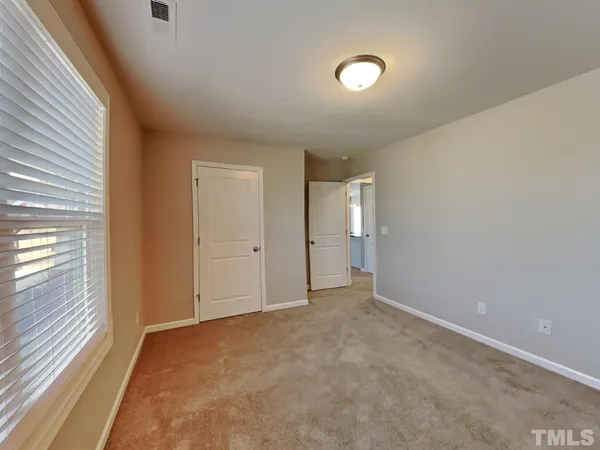 a view of an empty room and a window
