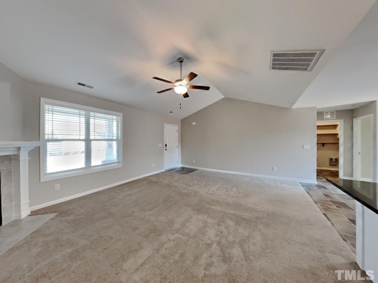 113 Cornfield Lane Benson, NC 27504 - Photo 2 of 19 a view of an empty room with a window