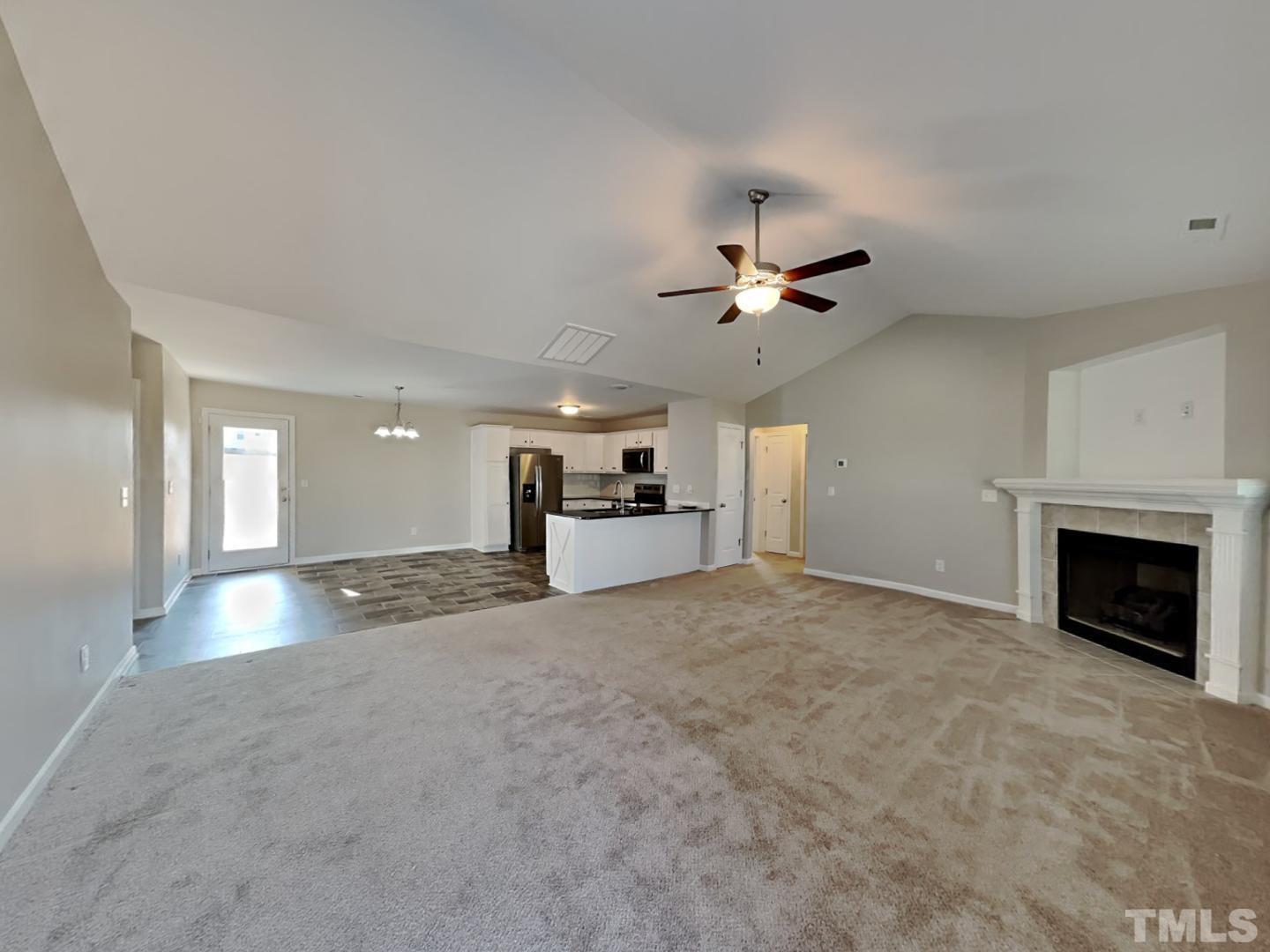 113 Cornfield Lane Benson, NC 27504 - Photo 6 of 19 a view of a livingroom with a fireplace and a ceiling fan
