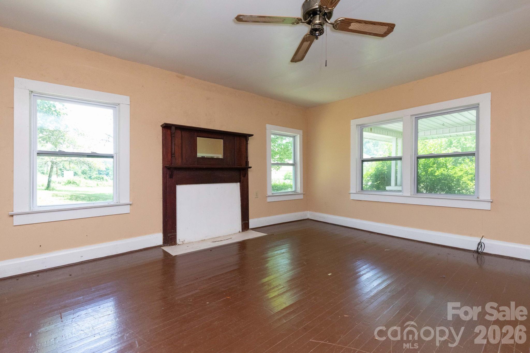 4085 Jacks Creek Road Burnsville, NC 28714 - Photo 8 of 24 a view of an empty room with wooden floor and a window