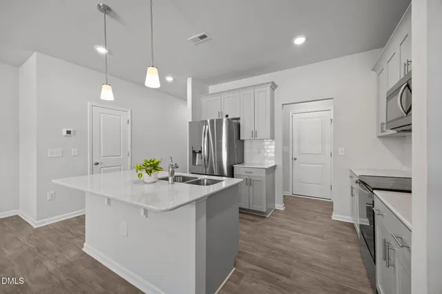 a stove top oven sitting inside of a kitchen