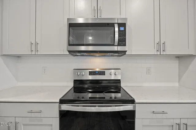 a view of a kitchen counter a sink and chandelier