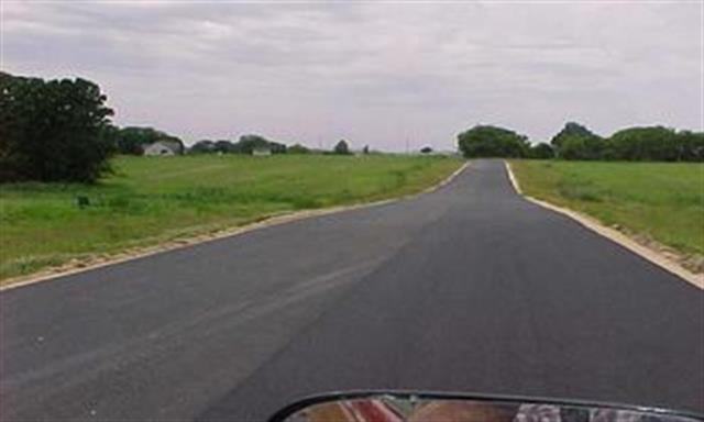 705 Keller Drive Dixon, IL 61021 - Photo 5 of 7 a view of a street with a big yard and a large trees