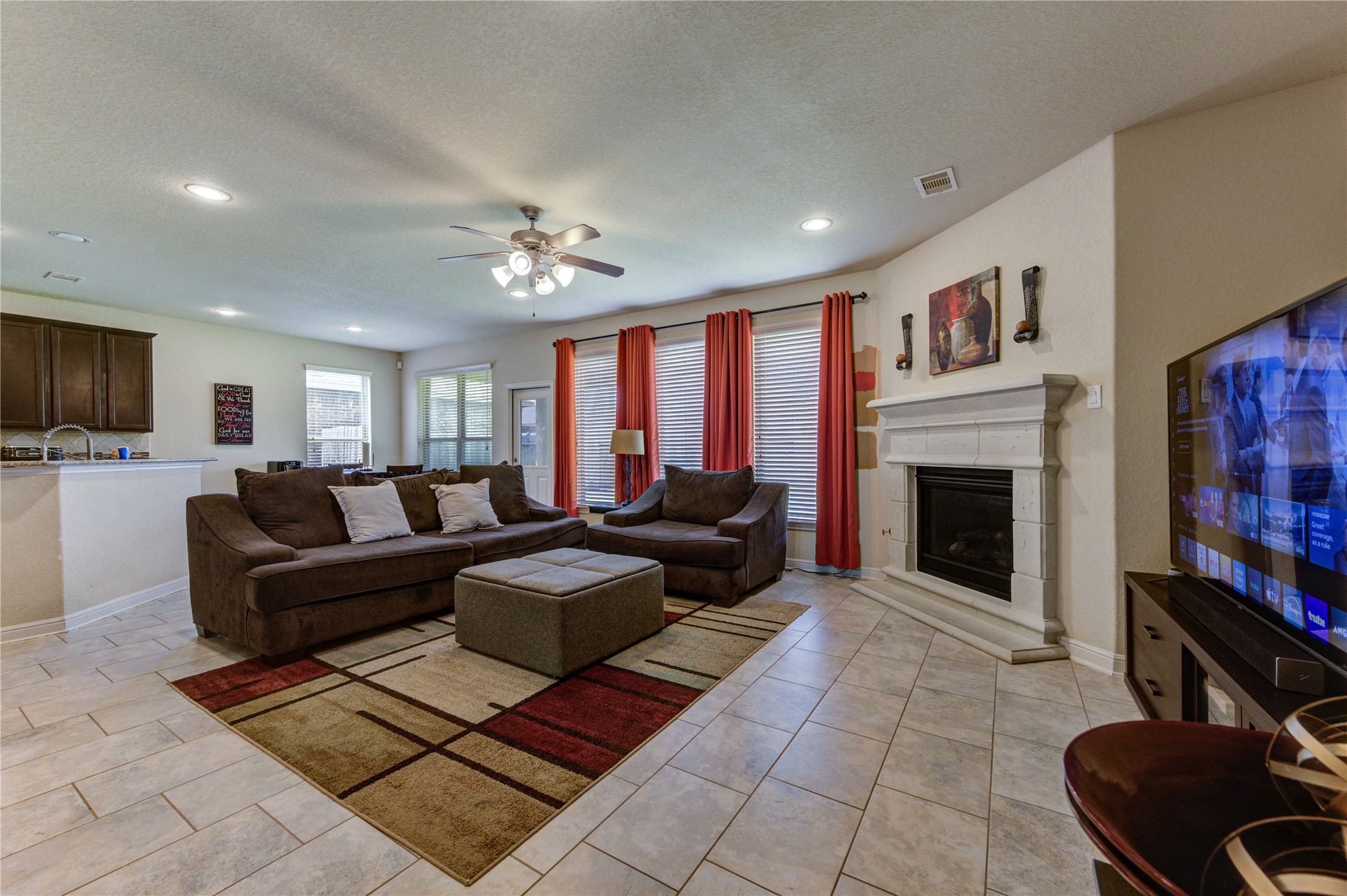 24511 Stratton Creek Drive Spring, TX 77373 - Photo 6 of 27 The open-concept living area features beautiful tile flooring, soaring ceilings, and a cozy gas fireplace, creating the perfect gathering space for family and friends.