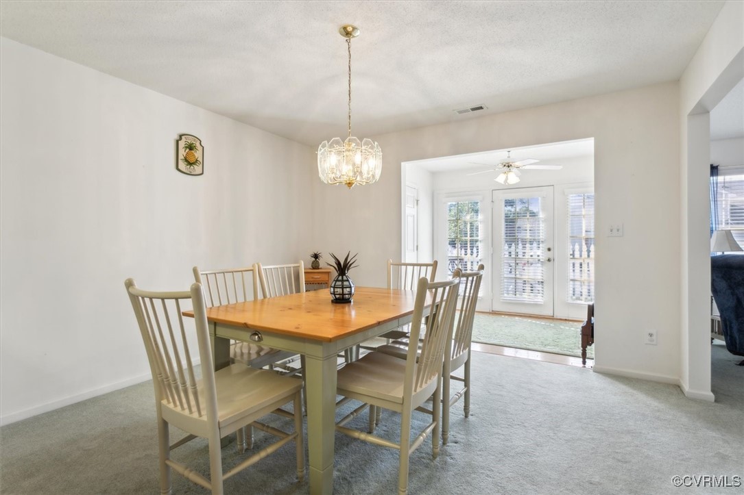 2104 Westgate Circle Williamsburg, VA 23185 - Photo 19 of 45 a view of a dining room with furniture and chandelier